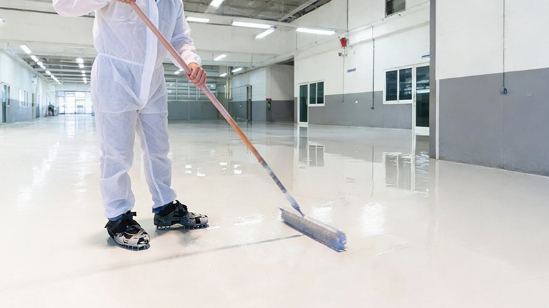 Polyurea flooring coating application on industrial floor surface