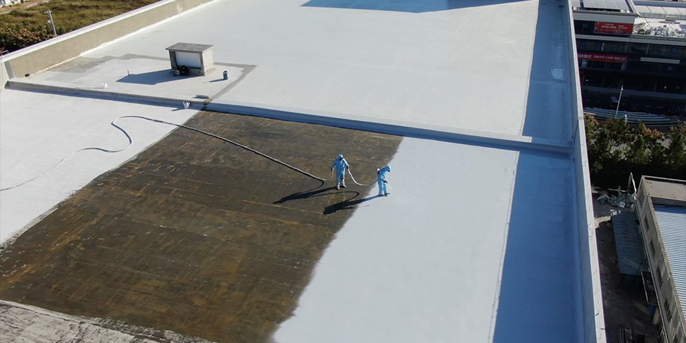 Roof waterproofing application with polyurea coating on a large flat roof