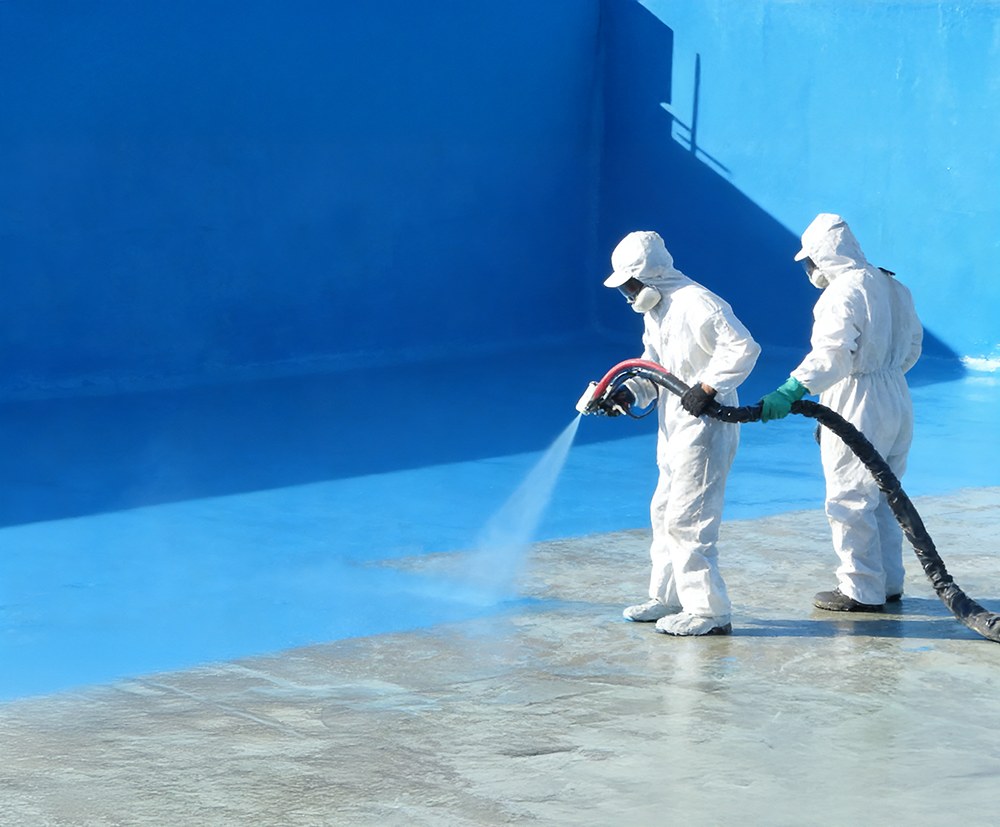 Spray polyurea waterproof coating applied by workers using high-pressure spray equipment for industrial waterproofing protection.