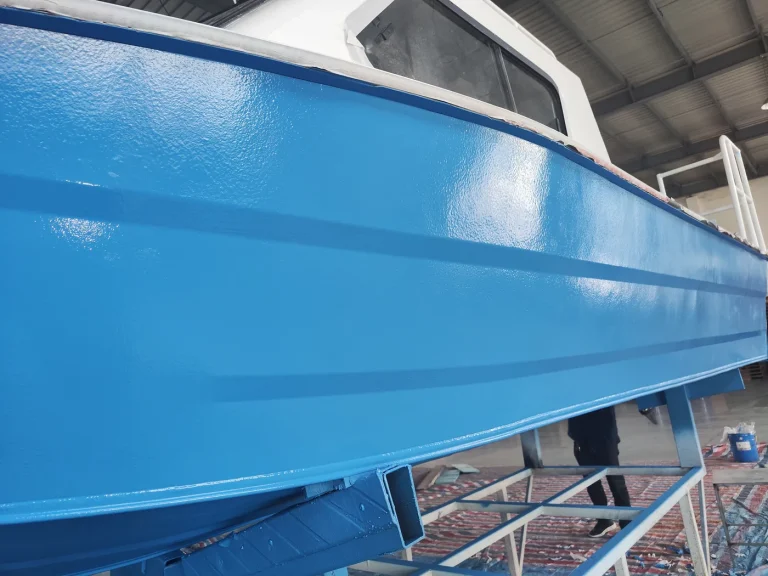 Finished blue BW0-8028 polyaspartic anticorrosion coating on a metal boat hull