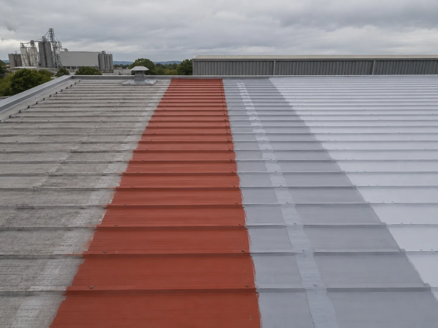 Color steel roof polyurea coating system showing metal substrate, primer and protective topcoat