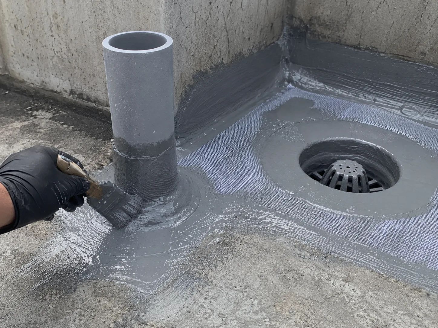 Polyurea detail treatment around pipe root and roof drain with reinforcement mesh