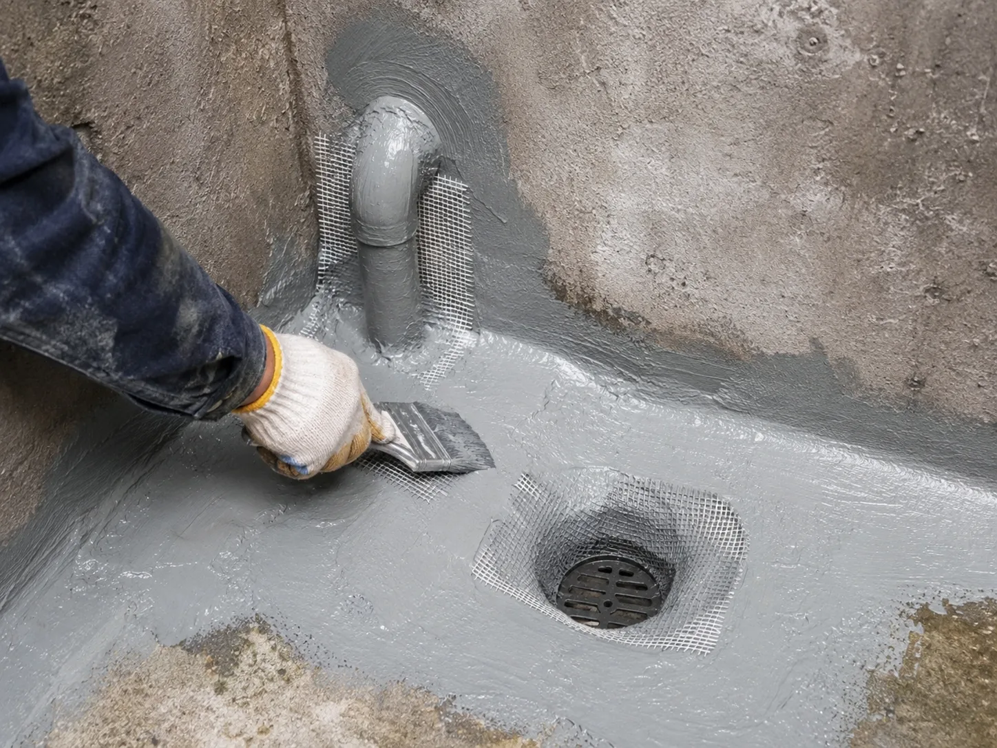 Polyurea water tank detail treatment around pipe root and drain with reinforcement mesh