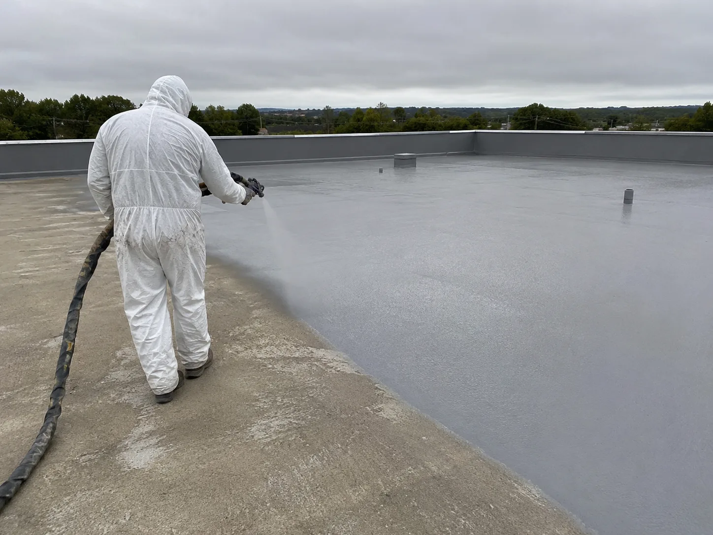 Spray polyurea application on a large concrete roof waterproofing project