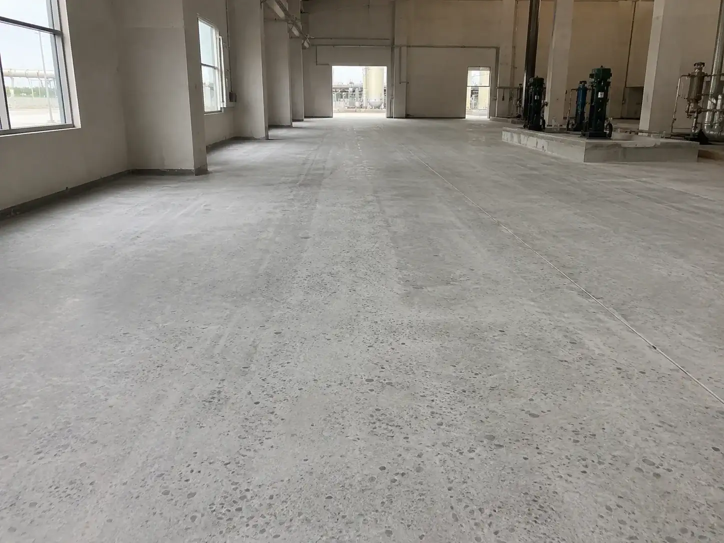 Concrete floor surface preparation before hand-applied polyurea floor system