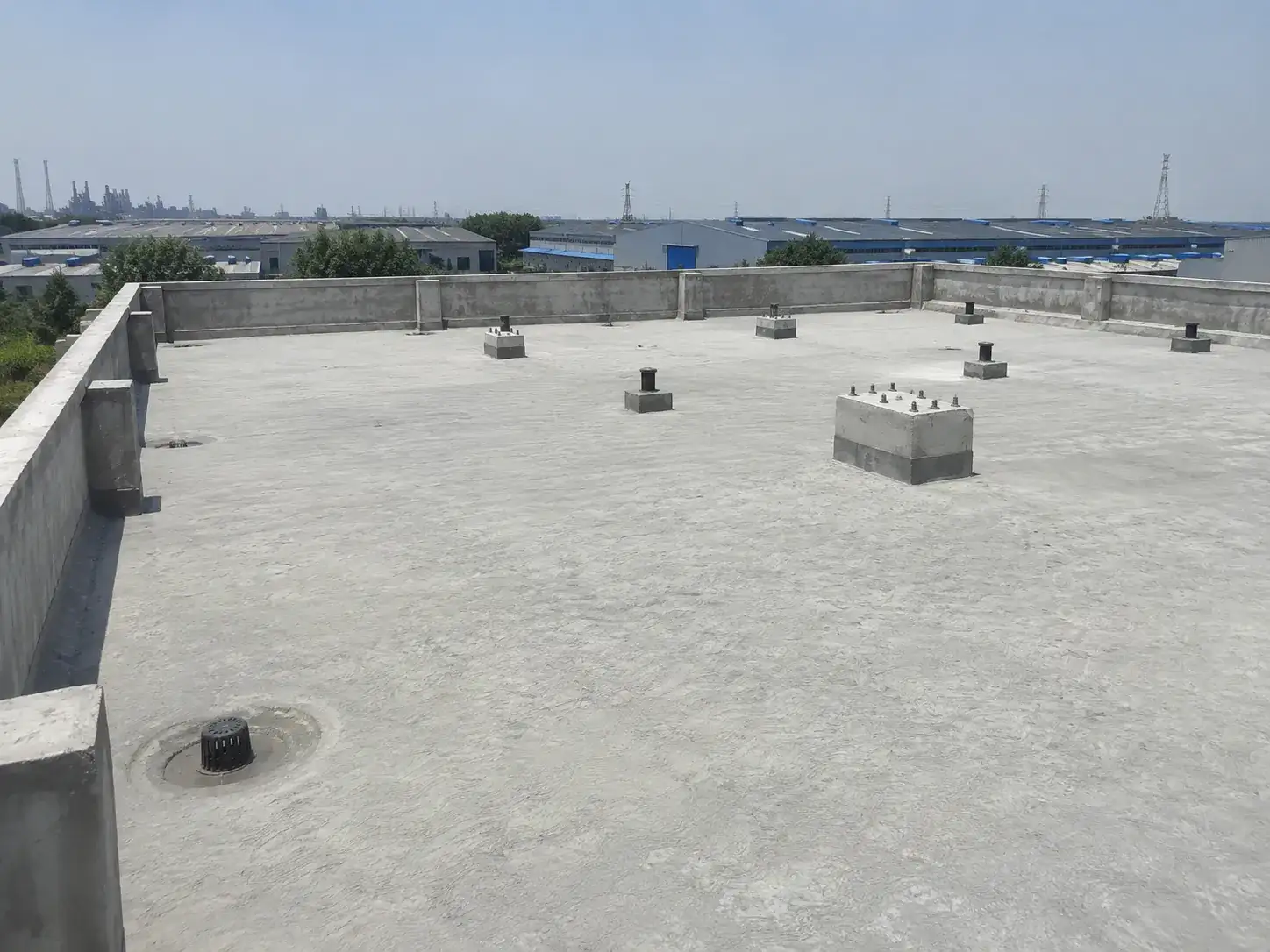 Prepared concrete roof substrate before BW8010 primer repair and hand-applied polyurea membrane