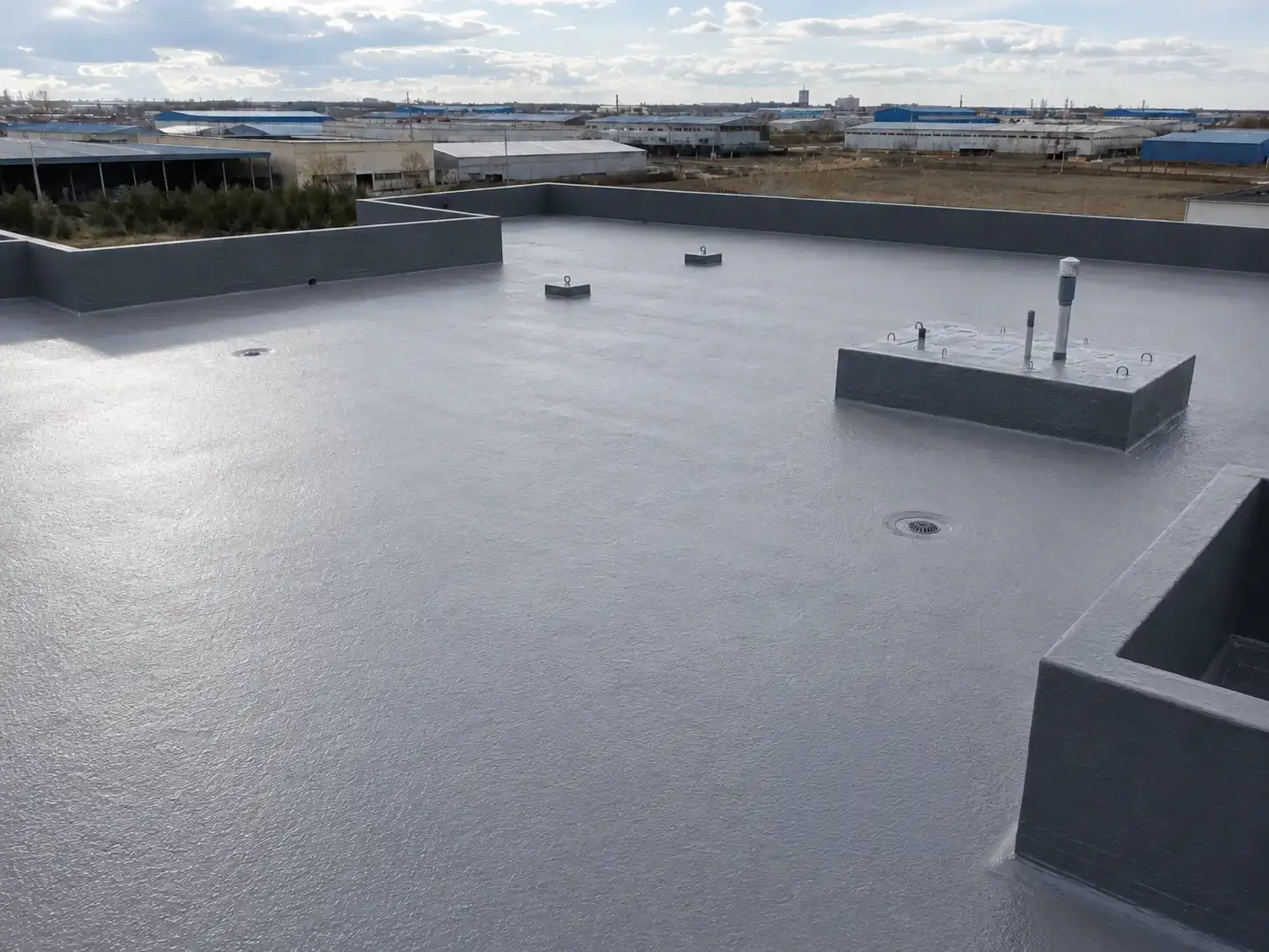 BW3-900 spray polyurea waterproofing membrane forming a seamless roof protection layer around roof details