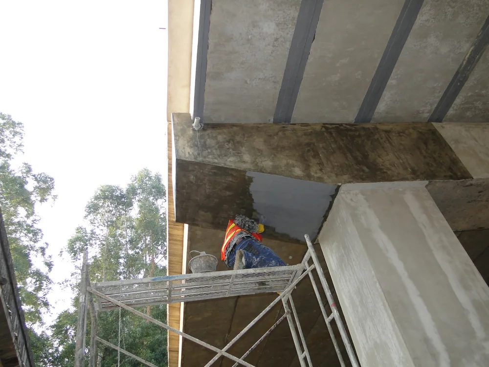 Bridge beam underside with hand-applied polyurea repair coating
