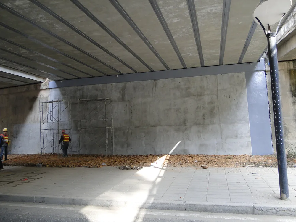 Bridge underside concrete repair area with waterproofing protection