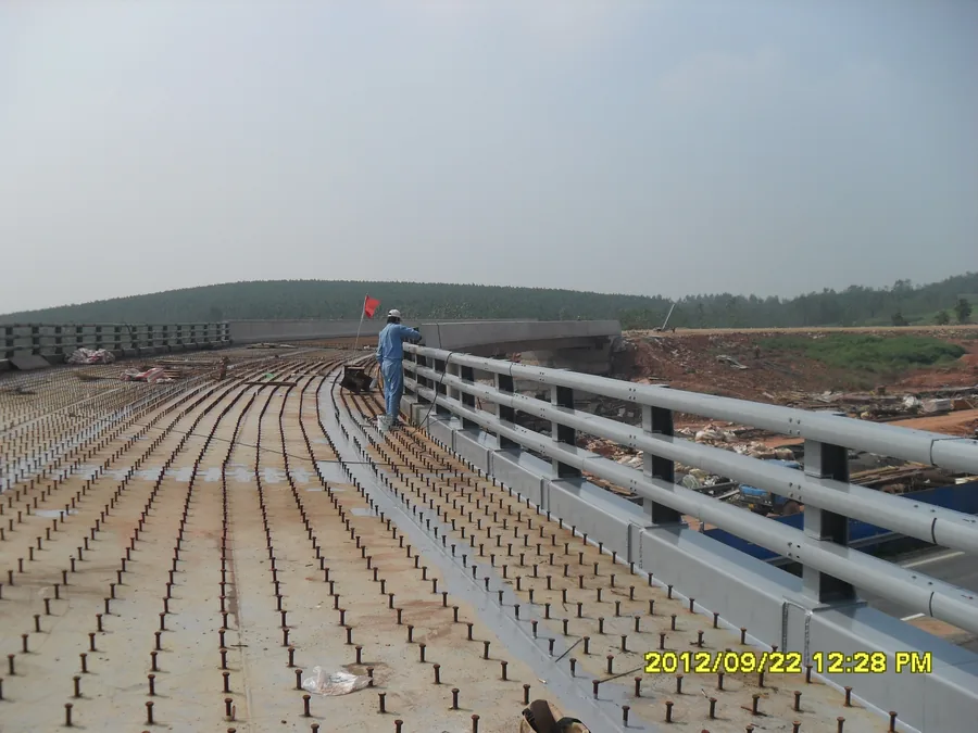 Bridge deck edge with steel guardrail coating work