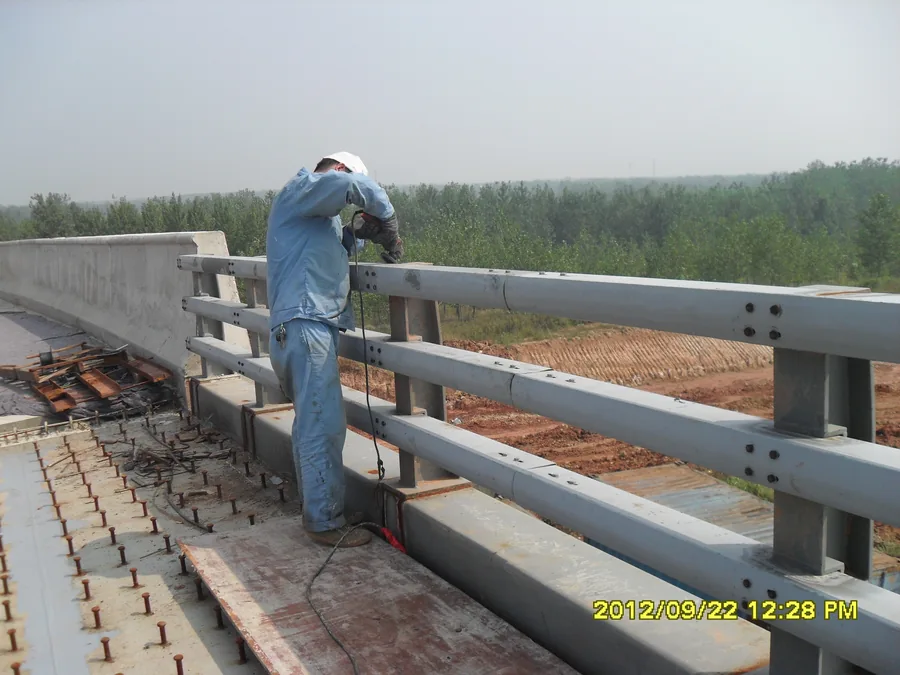 Worker coating bridge guardrail member with BW6-959 protective coating