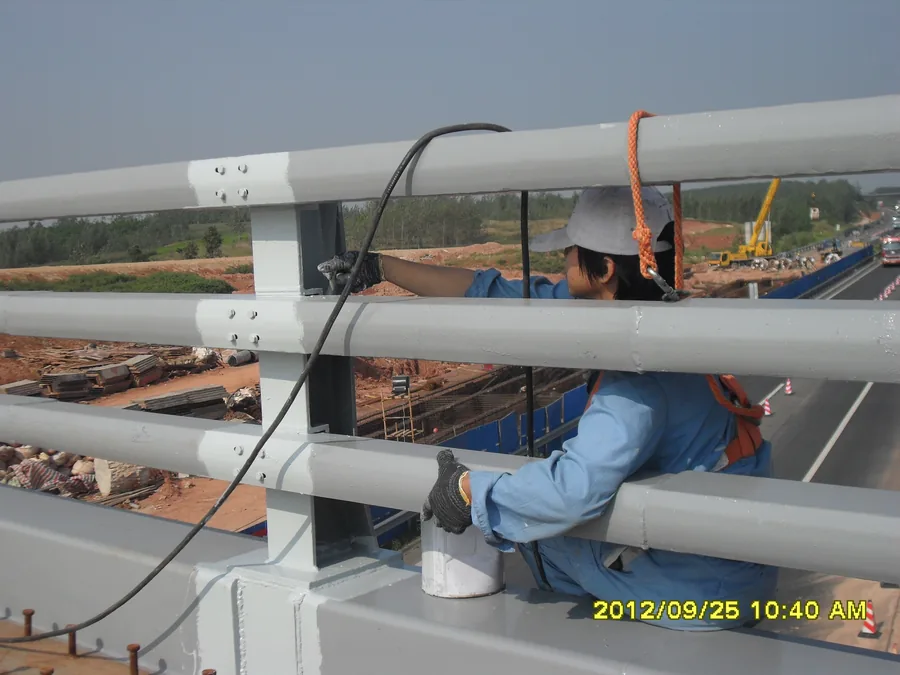 Bridge guardrail coating work along outdoor bridge edge