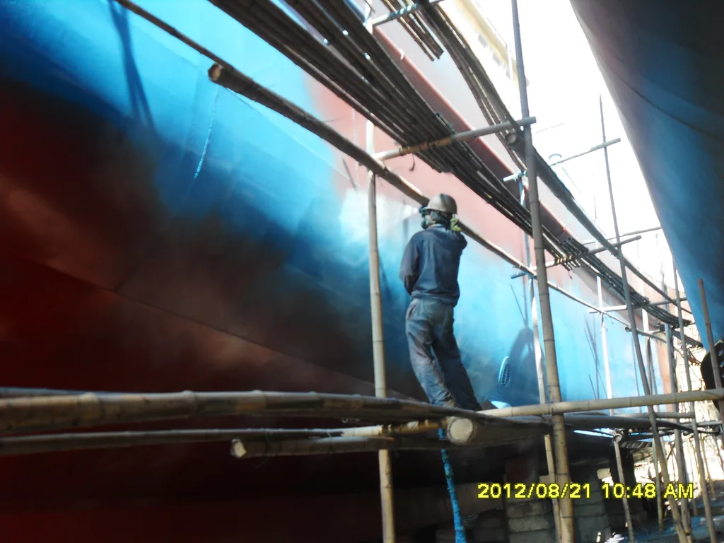 Spray polyurea coating work on fishing boat hull surface