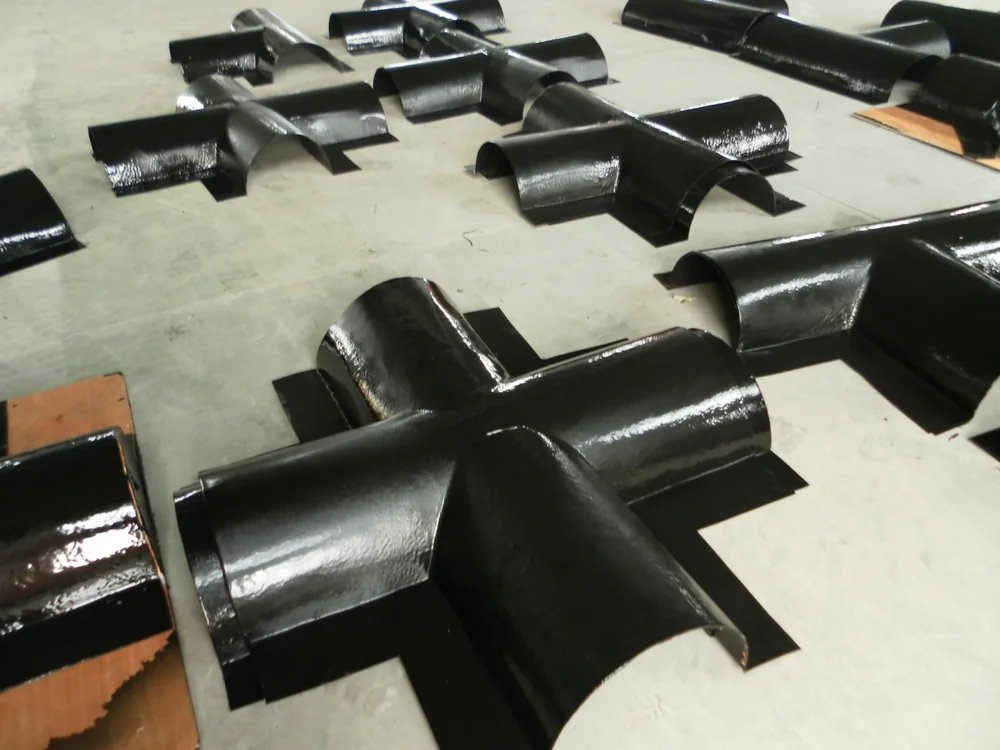 Curved hydraulic steel components with continuous spray polyurea protection