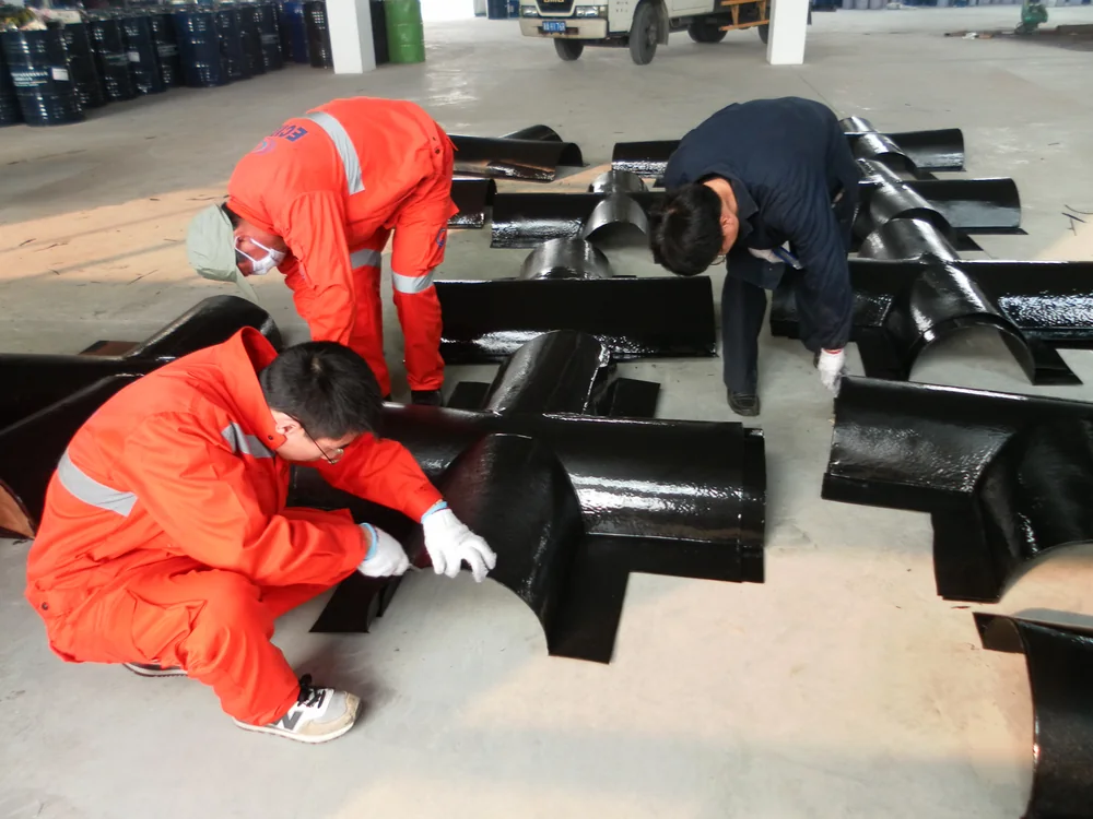 Workers inspecting finished dam equipment protective coating