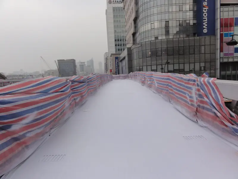 Urban pedestrian bridge walkway surface protected with spray polyurea system