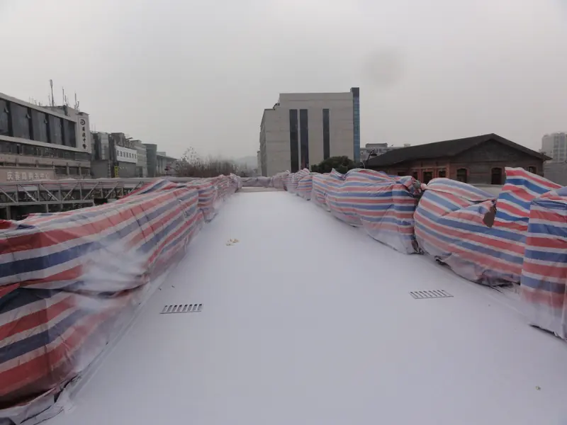 Finished pedestrian bridge deck coating with drainage opening detail