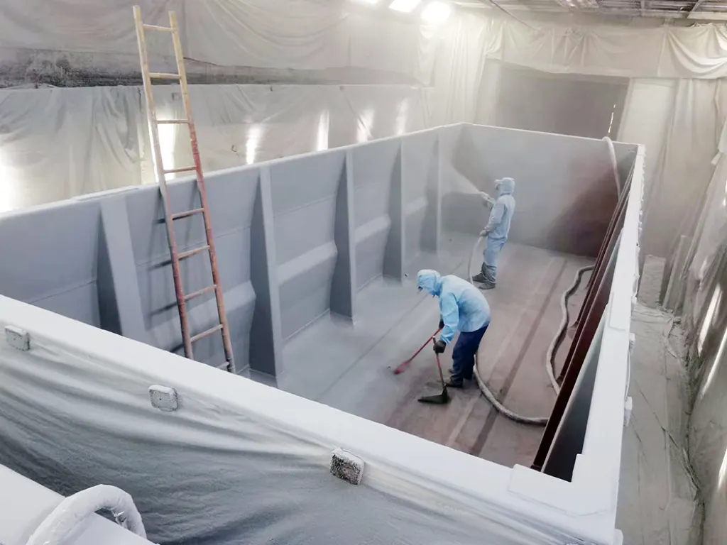 Spray application of polyurea coating inside mining truck