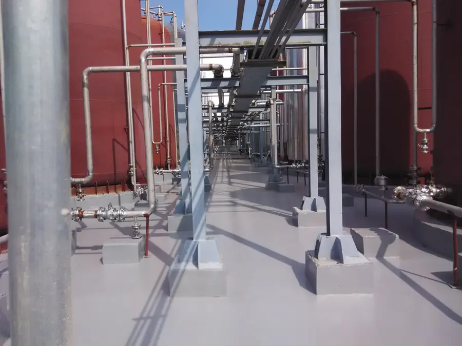 Exposed industrial floor coating for outdoor chemical tank farm