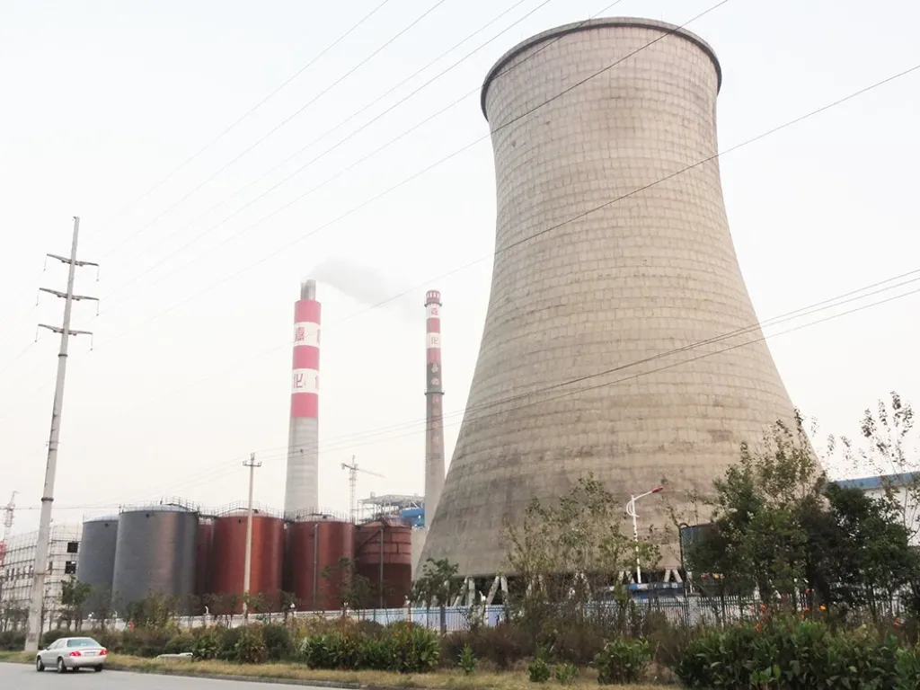 Power plant industrial area with storage tanks and cooling tower