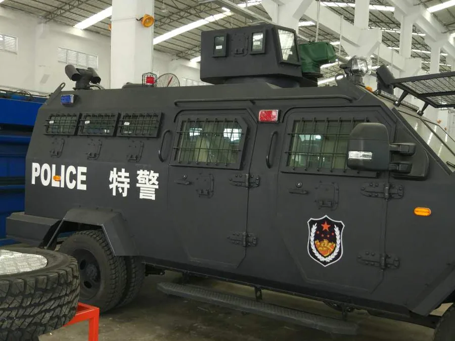 Finished side panel of riot control vehicle with textured spray polyurea coating