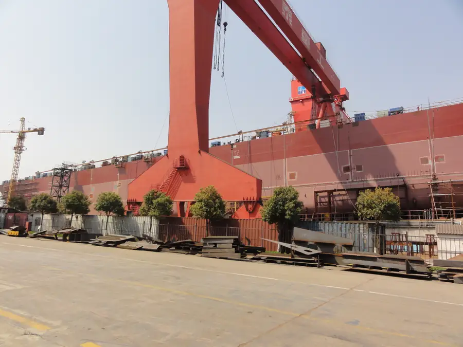 Large ship hull coating work in shipyard with spray polyurea protection