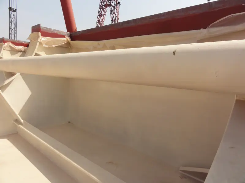 Curved ship compartment steel surface with protective polyurea coating