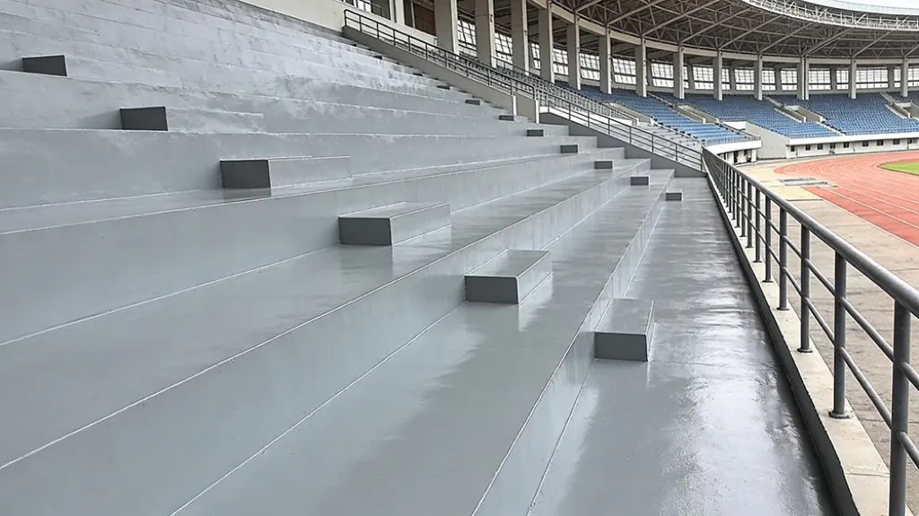 Stadium stand polyurea coating texture for waterproofing and wear protection