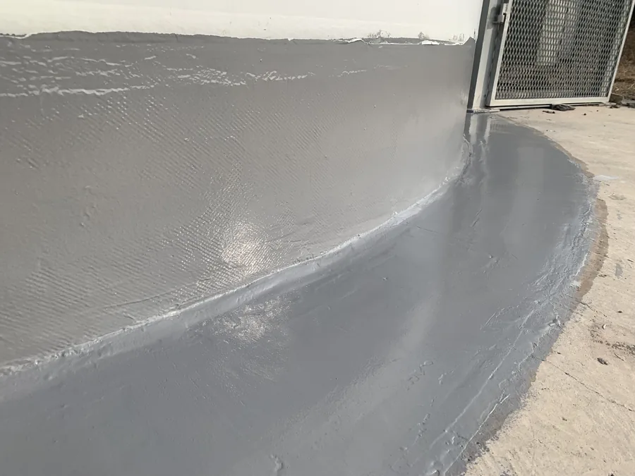 Finished wind turbine base transition with gray hand-applied polyurea coating